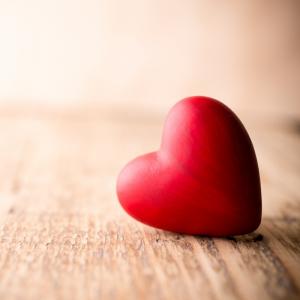 a heart on its side laying on a wood grain background