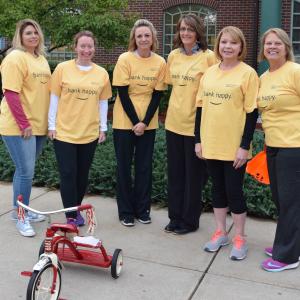 The 2018 Trike Race champions of Community Bank N.A. pose with their tricycle. 